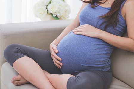 pregnant woman sitting on the sofa